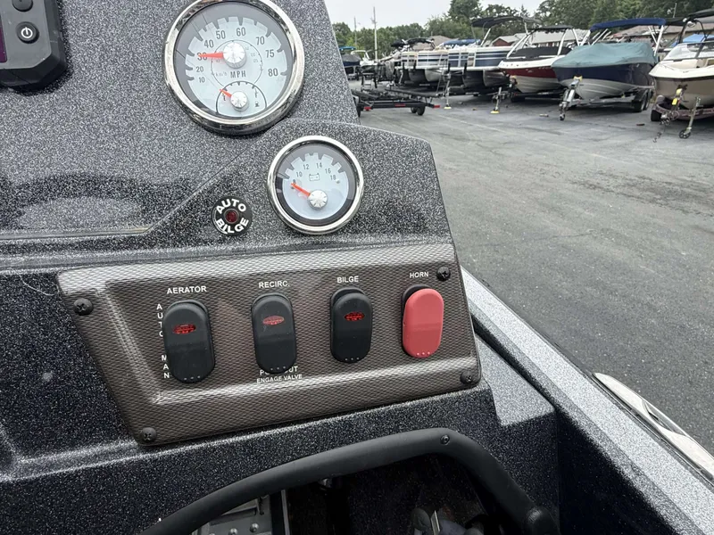 Slide: The Image of Dashboard of a Nitro Z18 Pro boat with switches and gauges. - 9