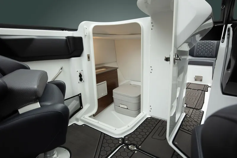Slide: The Image of Interior view of a 2026 Scarab 255 LX featuring a small toilet and modern seating. - 11