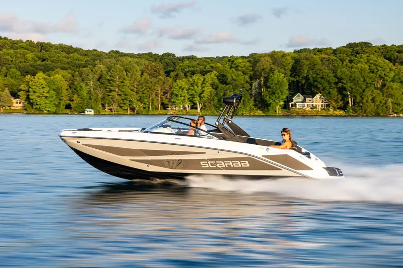 The Image of 2026 Scarab 255 LX speeding across a lake. - 13