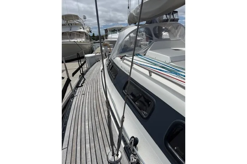 Slide: The Image of 2000 X-Yachts X-362 Sport sailboat docked, showcasing sleek deck design and rigging. - 28