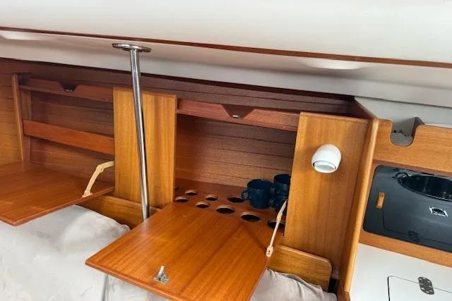 Slide: The Image of Interior of 2000 X-Yachts X-362 Sport with wooden cabinets and cup storage. - 15