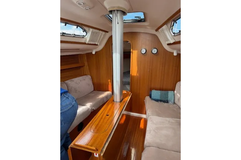 Slide: The Image of Interior of 2000 X-Yachts X-362 Sport, featuring cozy seating and wooden finishes. - 9