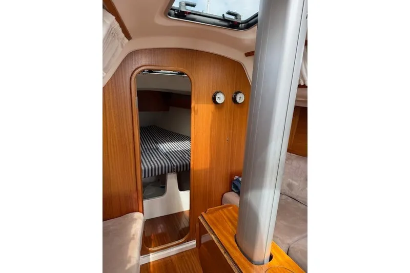 Slide: The Image of Interior of 2000 X-Yachts X-362 Sport, featuring wood paneling and cozy cabin space. - 18