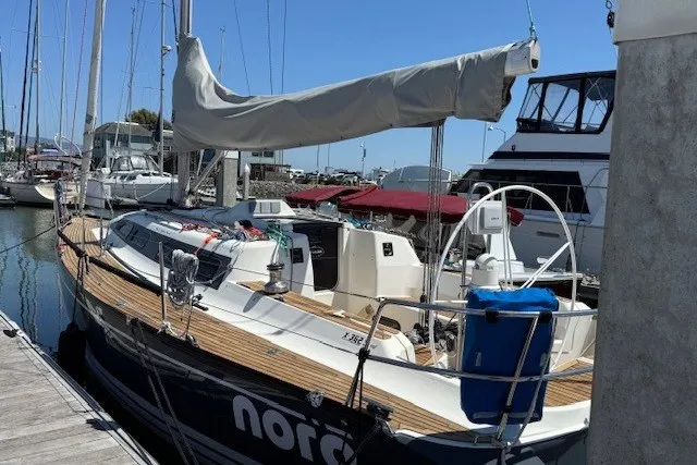 Slide: The Image of Sailboat X-Yachts X-362 Sport 2000 docked at marina, featuring sleek design and wooden deck. - 4