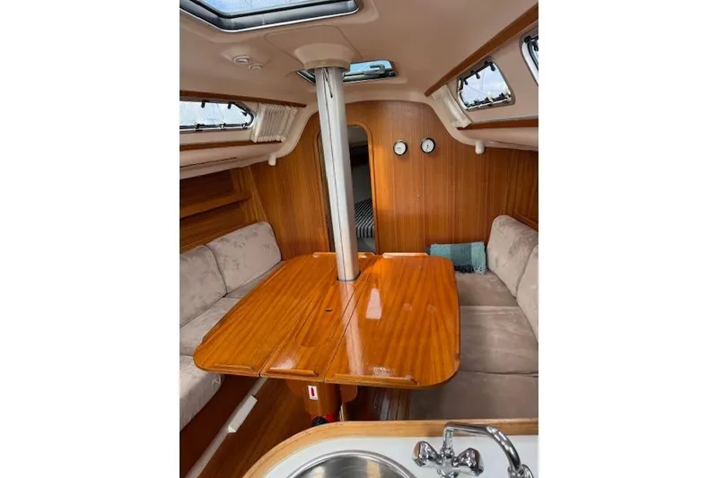 Slide: The Image of Interior of 2000 X-Yachts X-362 Sport with wooden table and beige seating. - 10