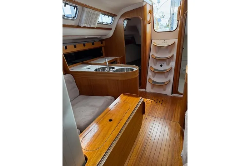 Slide: The Image of Interior of 2000 X-Yachts X-362 Sport, featuring wooden cabinetry and seating. - 11