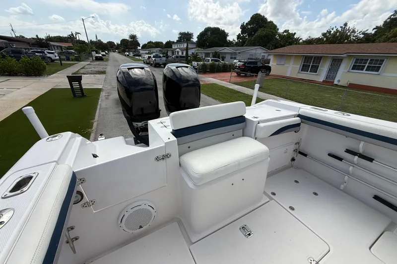 Slide: The Image of 2007 Donzi 29 ZF Open boat with dual engines, parked in a residential area. - 10