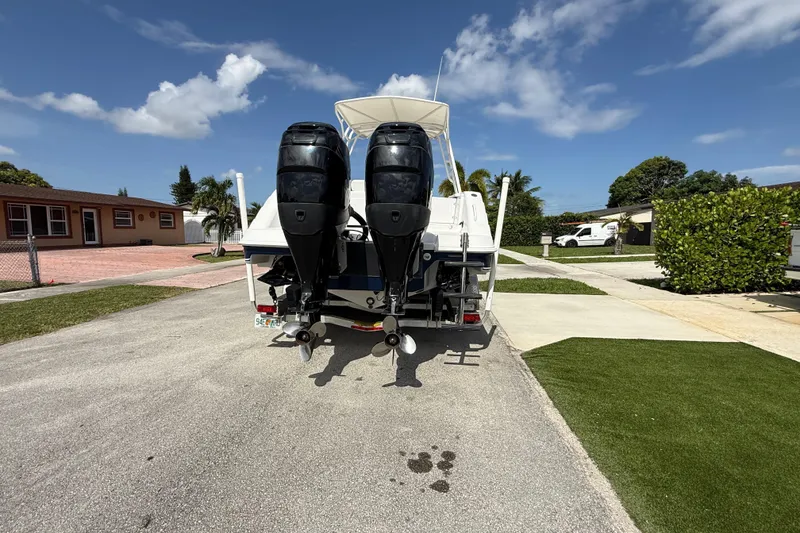 Slide: The Image of 2007 Donzi 29 ZF Open boat with dual outboard motors parked in a residential area. - 5