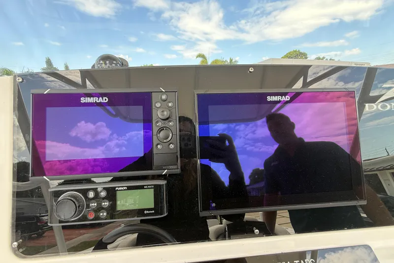 Slide: The Image of Dashboard of a 2007 Donzi 29 ZF Open boat with Simrad navigation displays. - 30