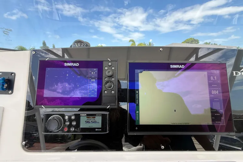 Slide: The Image of Dashboard of a 2007 Donzi 29 ZF Open with Simrad navigation displays. - 34
