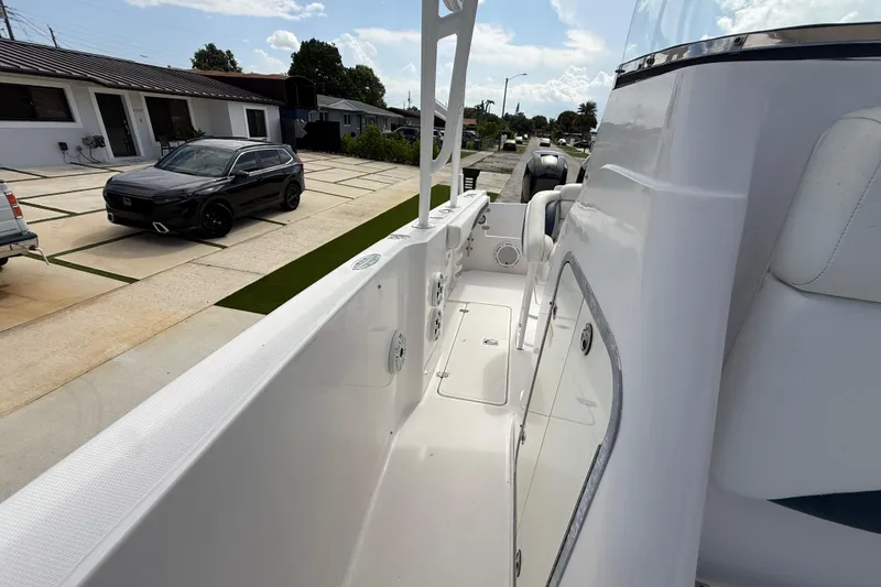 Slide: The Image of 2007 Donzi 29 ZF Open boat parked in a residential driveway, showcasing sleek design. - 46