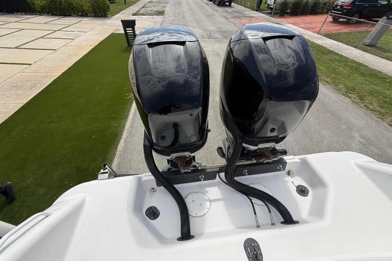 Slide: The Image of Twin outboard motors on a 2007 Donzi 29 ZF Open boat, parked on a driveway. - 61