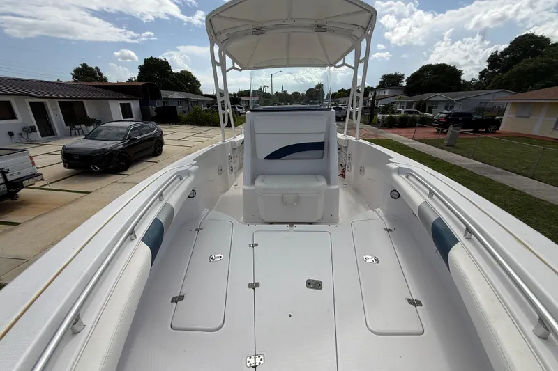 Slide: The Image of 2007 Donzi 29 ZF Open boat with spacious deck and seating, parked in a residential area. - 45