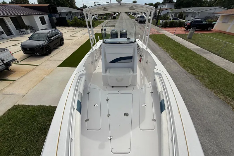 Slide: The Image of 2007 Donzi 29 ZF Open boat parked on a residential street, showcasing spacious deck layout. - 49