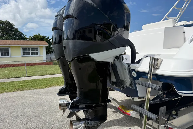 Slide: The Image of 2007 Donzi 29 ZF Open boat with dual outboard motors, parked on a trailer. - 62