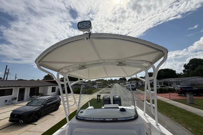 Slide: The Image of 2007 Donzi 29 ZF Open boat with T-top, parked in a residential neighborhood. - 48