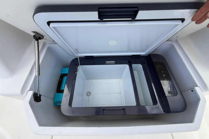 Slide: The Image of Open storage compartment on a 2007 Donzi 29 ZF Open boat, featuring a cooler and control panel. - 40