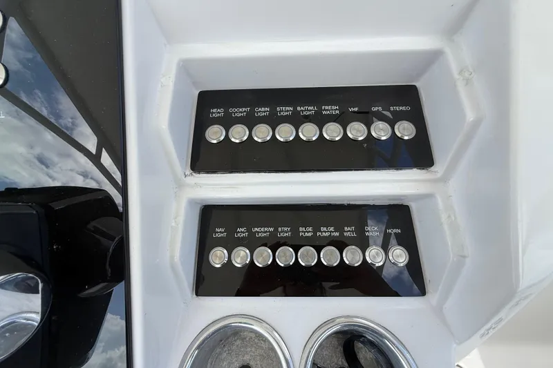 Slide: The Image of Control panel of a 2007 Donzi 29 ZF Open boat with labeled switches. - 24