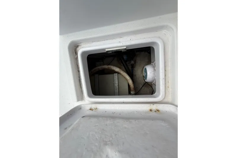 Slide: The Image of Storage compartment inside a 2007 Donzi 29 ZF Open boat, showing interior components. - 18