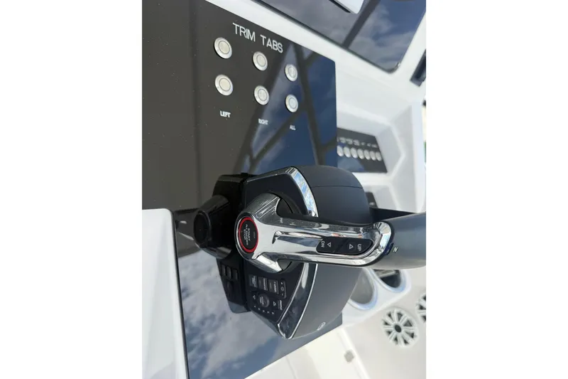 Slide: The Image of Control panel of a 2007 Donzi 29 ZF Open boat, featuring trim tab buttons. - 35