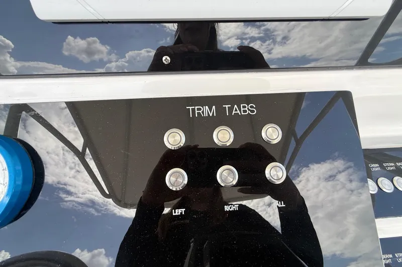 Slide: The Image of Control panel of 2007 Donzi 29 ZF Open boat with trim tab buttons. - 25