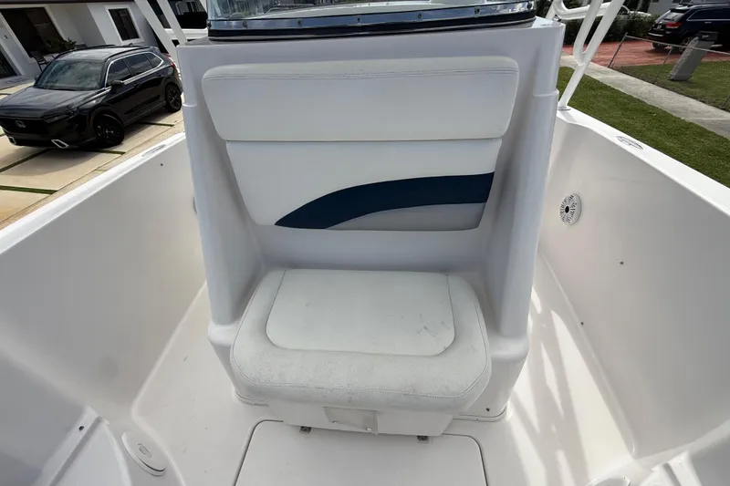 Slide: The Image of 2007 Donzi 29 ZF Open boat seat, white with blue accent, in outdoor setting. - 47