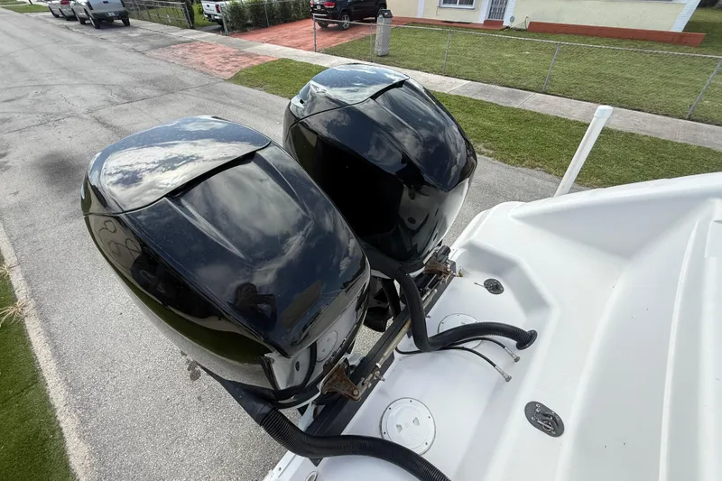 Slide: The Image of Twin outboard motors on a 2007 Donzi 29 ZF Open boat, parked on a street. - 6
