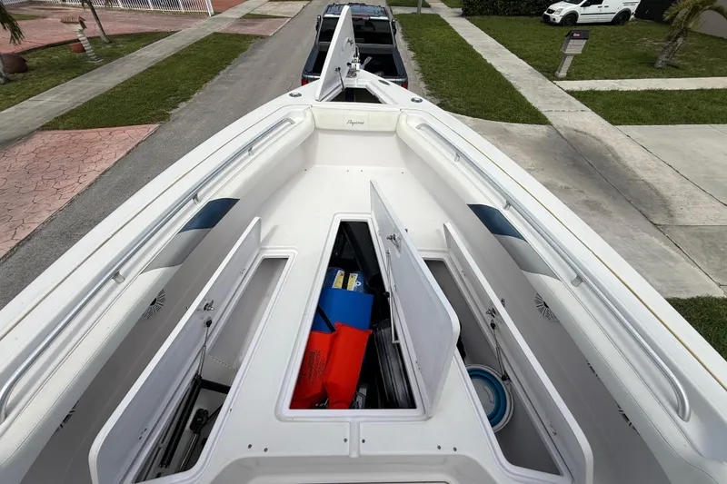 Slide: The Image of 2007 Donzi 29 ZF Open boat with open storage compartments, parked on a residential street. - 41