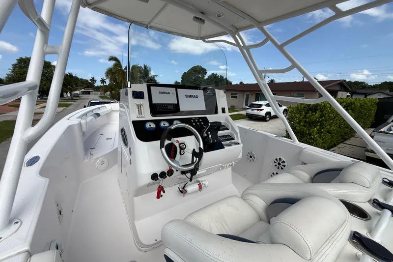Slide: The Image of 2007 Donzi 29 ZF Open boat interior with steering wheel and control panel. - 22