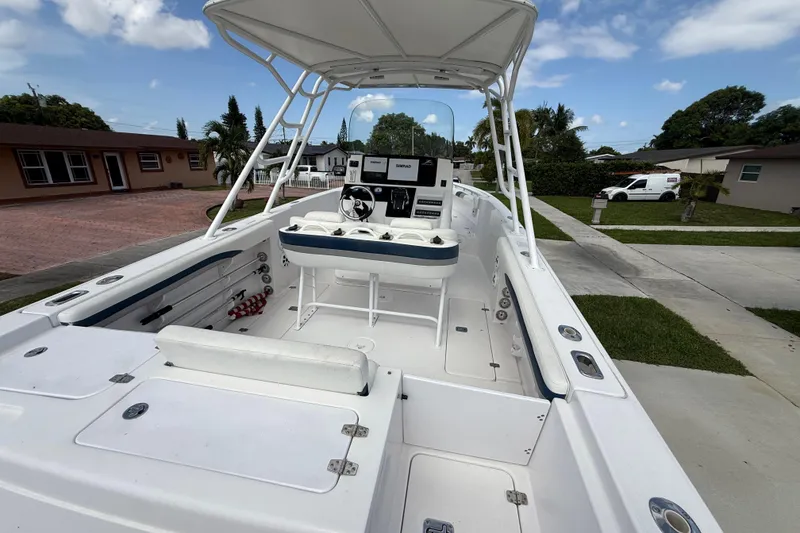 Slide: The Image of 2007 Donzi 29 ZF Open boat with spacious deck and modern controls, parked in residential area. - 8