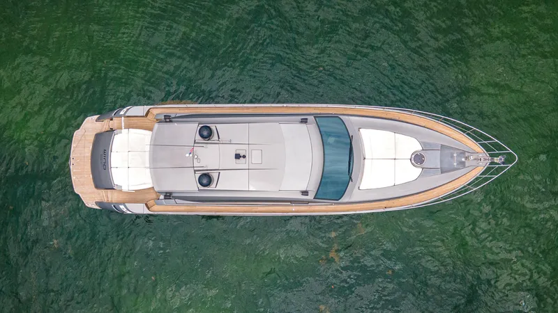 Slide: The Image of Aerial view of 2009 Pershing 64 yacht on green water. - 5