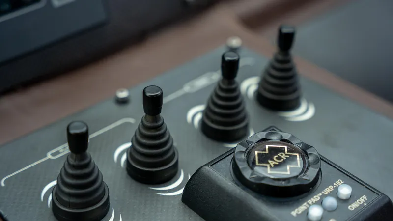Slide: The Image of Control panel of a 2009 Pershing 64 yacht with joystick controls and ACR button. - 24