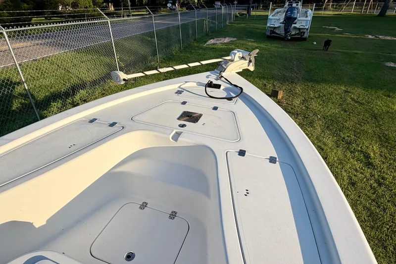 Slide: The Image of 2018 Sea Pro 208 Bay boat deck with trolling motor, parked on grass. - 8
