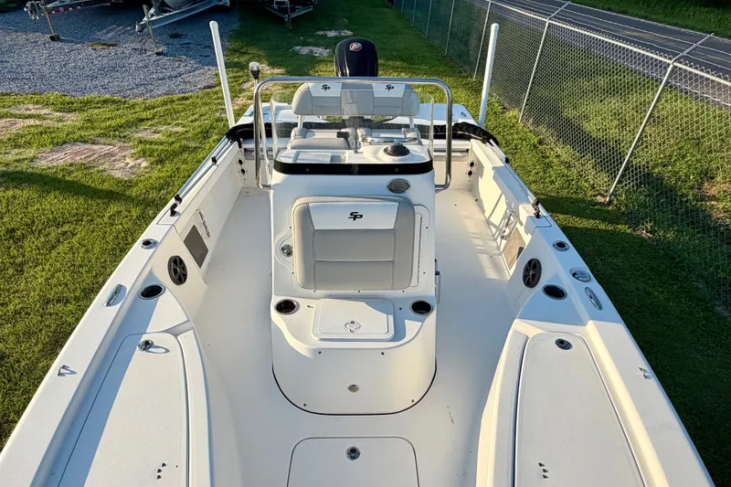 Slide: The Image of 2018 Sea Pro 208 Bay boat, white interior, spacious deck, and seating, parked on grass. - 9