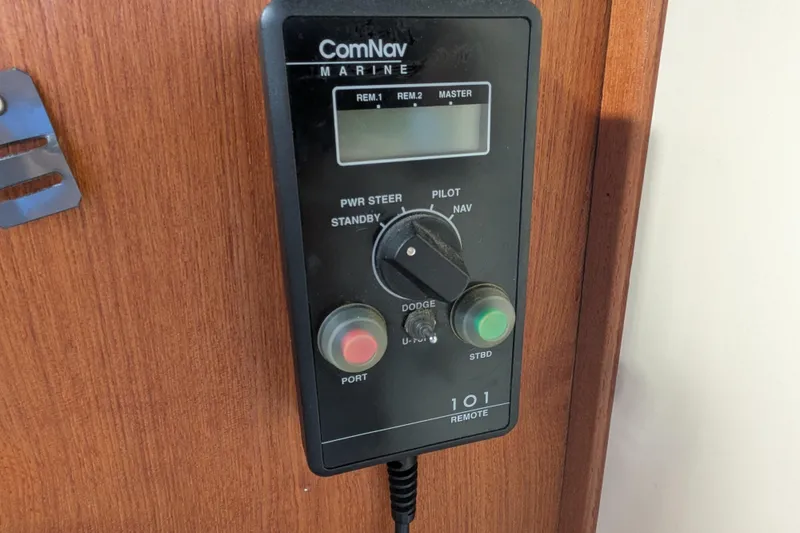 Slide: The Image of ComNav Marine control panel on 1998 Nordic Tug 32 boat, featuring navigation and steering controls. - 30