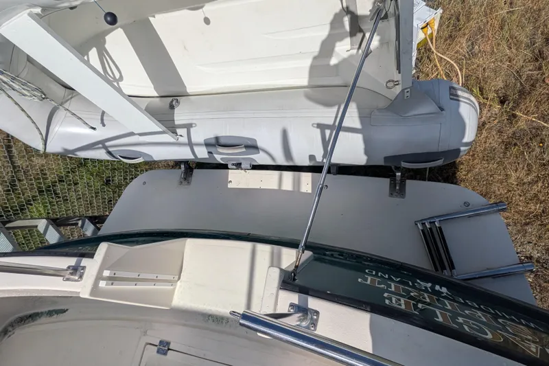 Slide: The Image of Nordic Tug 32 (1998) with dinghy on deck, featuring a ladder and railing. - 8