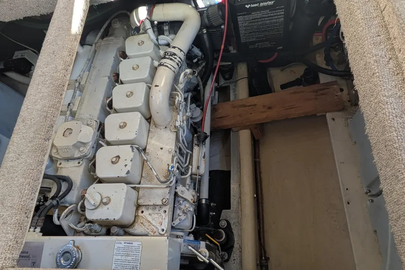 Slide: The Image of Engine compartment of a 1998 Nordic Tug 32, showcasing mechanical components and wiring. - 37