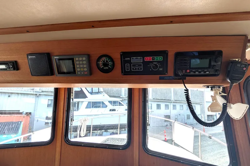 Slide: The Image of Interior dashboard of a 1998 Nordic Tug 32 with navigation and communication equipment. - 27