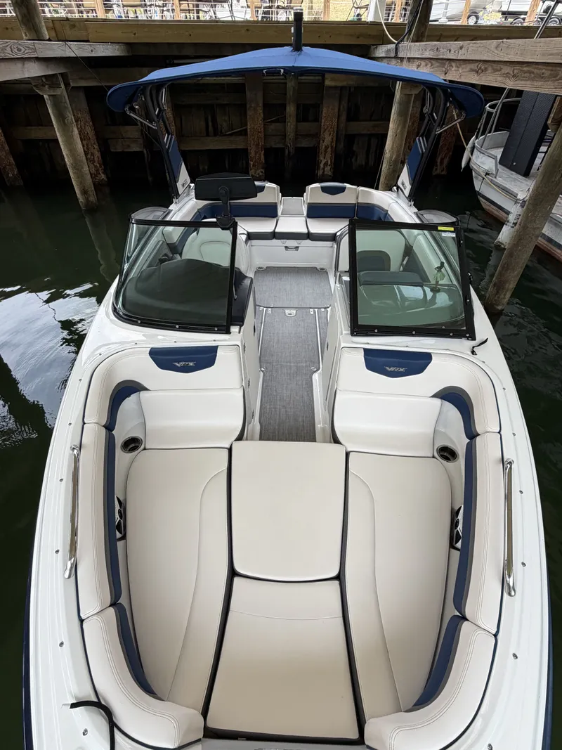 Slide: The Image of The image shows a 2016 Chaparral 223 Vortex boat with sleek white and blue seating. - 6