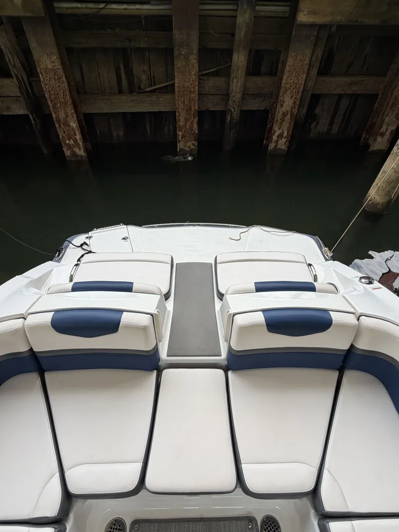 Slide: The Image of The image shows the stern of a Chaparral 223 Vortex boat with white and blue seating. - 7