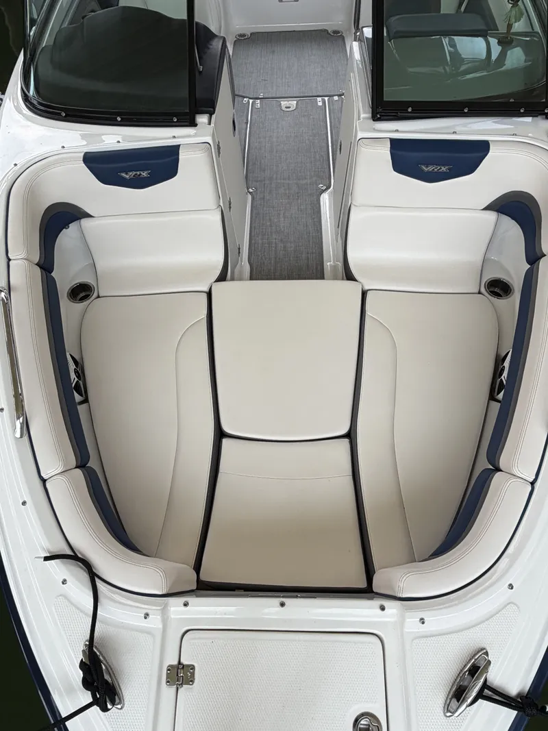 Slide: The Image of Interior view of a 2016 Chaparral 223 Vortex with beige and blue seating. - 9