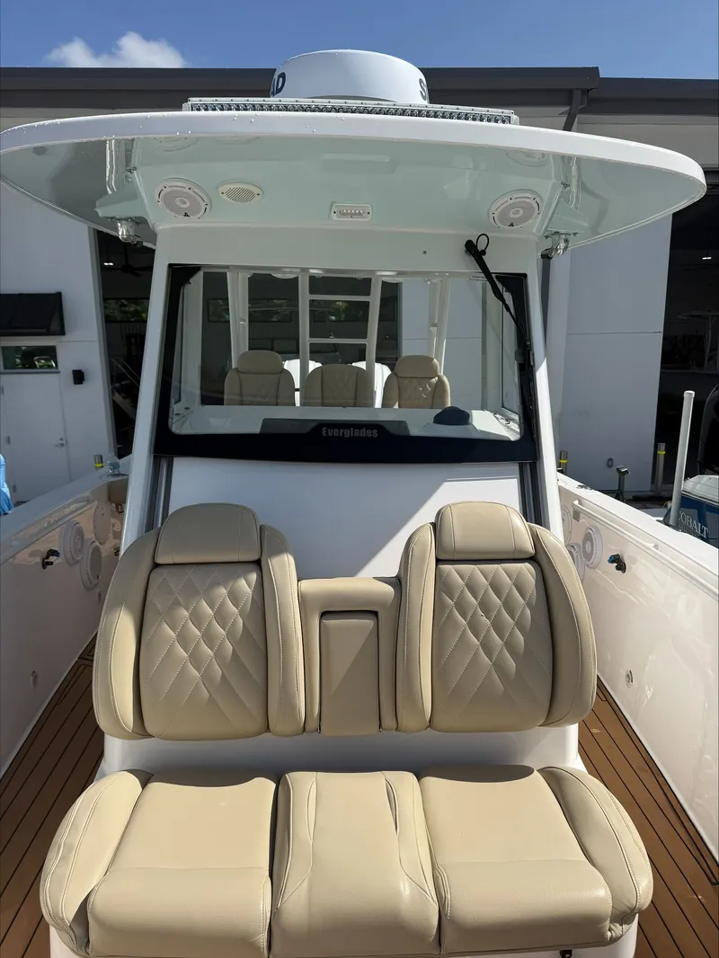 Slide: The Image of The image shows the cockpit of a 2020 Everglades 335 Center Console boat with beige seating. - 17