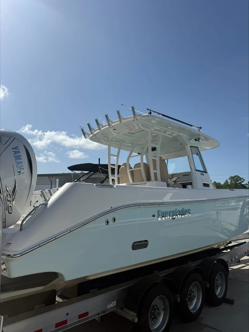 Slide: The Image of A 2020 Everglades 335 Center Console boat on a trailer, featuring Yamaha engines. - 6