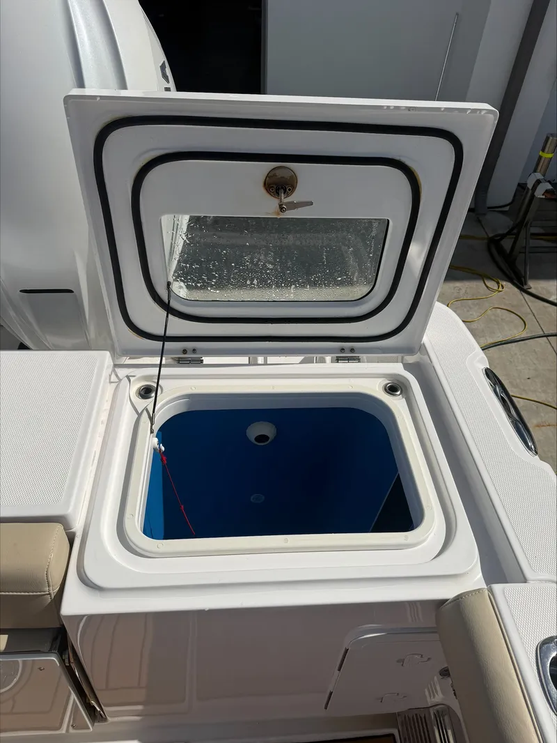 Slide: The Image of An open storage compartment on a 2020 Everglades 335 Center Console boat. - 12