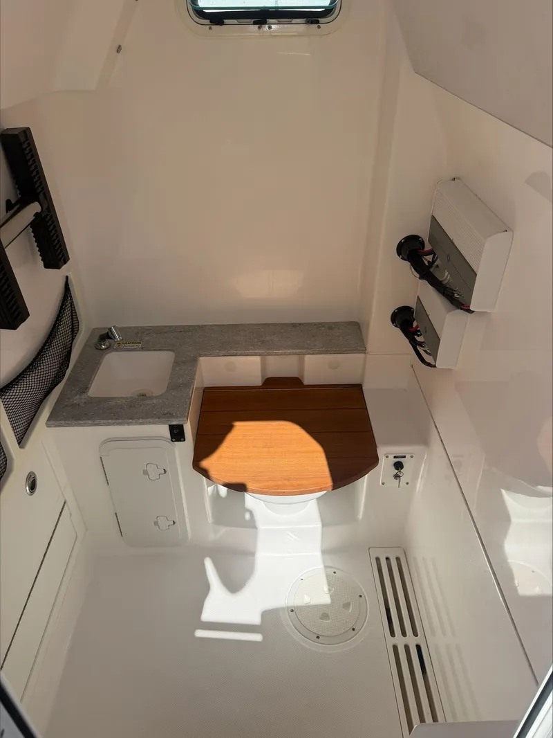 Slide: The Image of Interior of a modern boat cabin with sink, storage, and wooden countertop. - 11