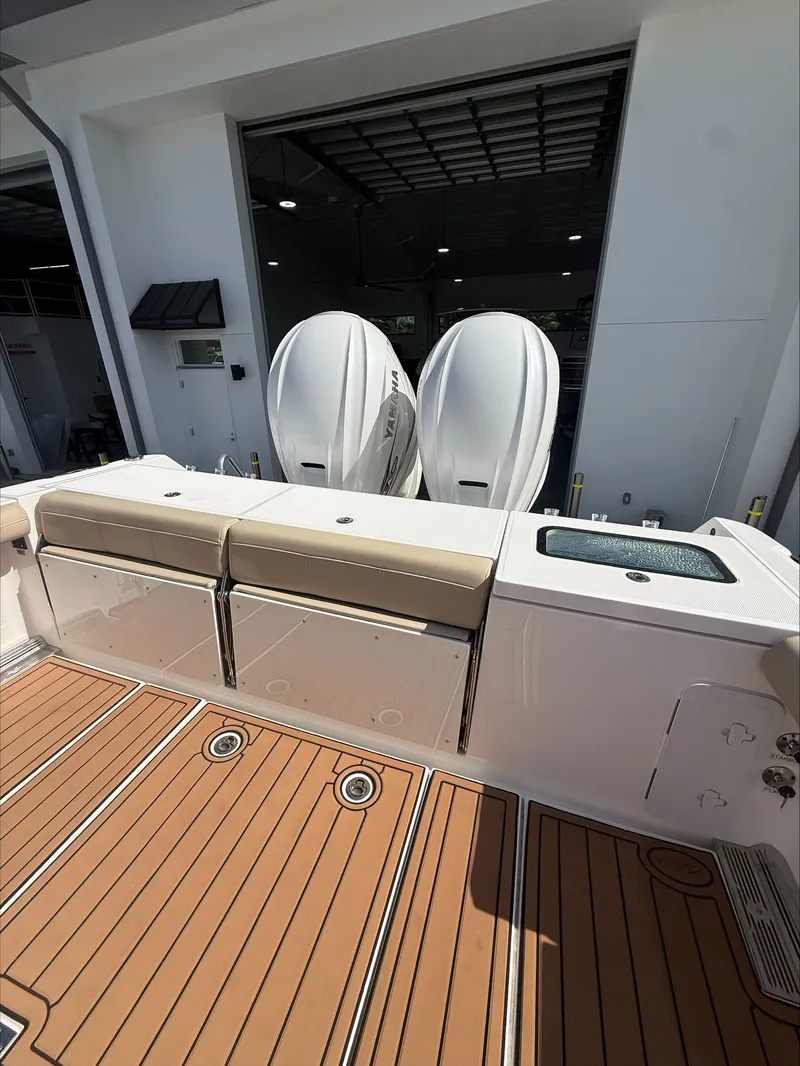 Slide: The Image of The image shows the stern of an Everglades 335 Center Console boat with two outboard engines. - 19