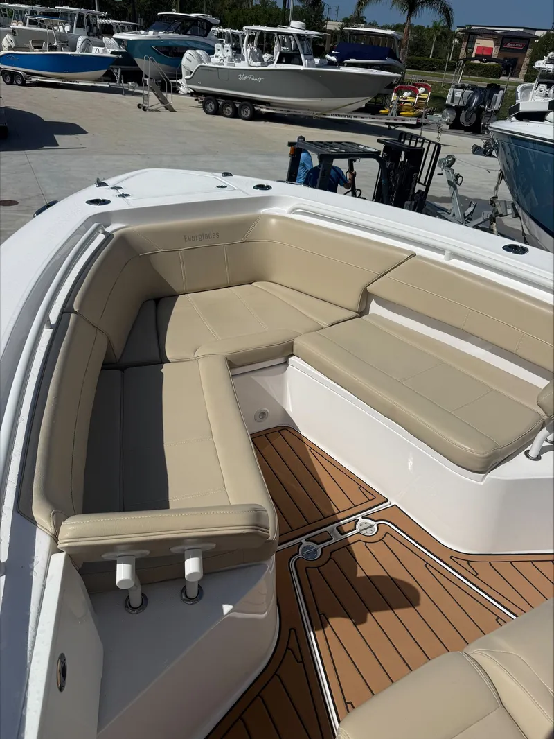 Slide: The Image of The image shows the bow area of a 2020 Everglades 335 Center Console boat with beige cushions. - 16