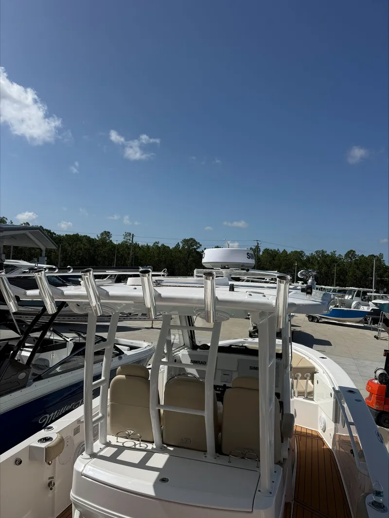 Slide: The Image of An Everglades 335 Center Console boat from 2020 is parked under a blue sky. - 20