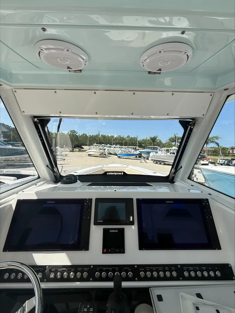 Slide: The Image of The cockpit of a 2020 Everglades 335 Center Console with multiple screens and controls. - 21