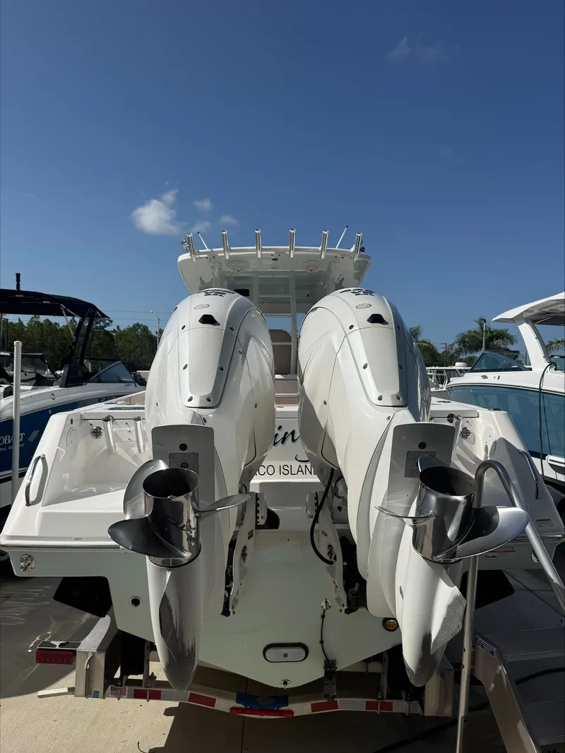 Slide: The Image of The image shows a 2020 Everglades 335 Center Console boat with two outboard engines. - 7